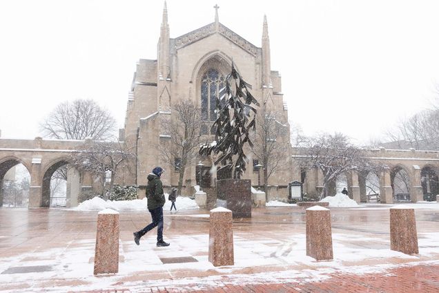 photo of students walking through the snow on Marsh Plaza.
