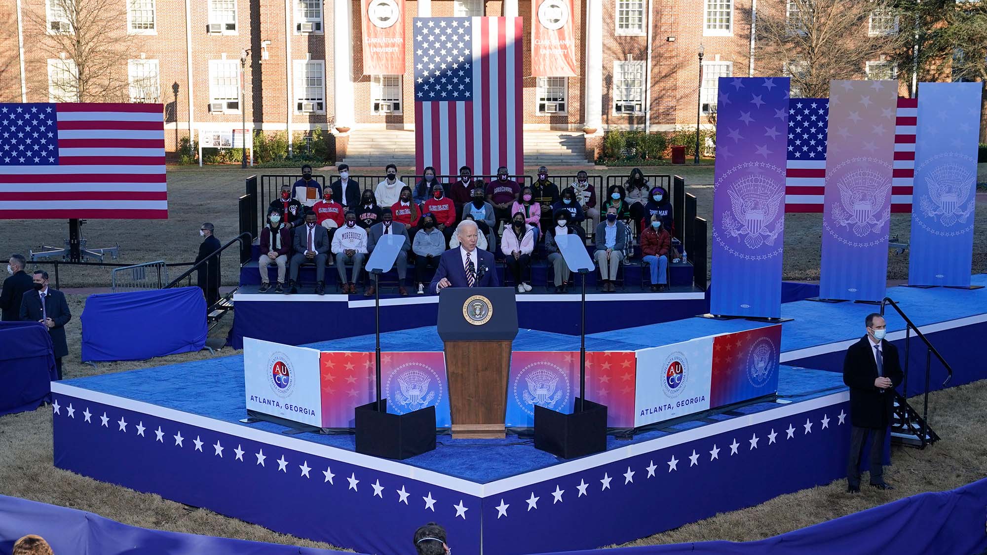 Photo of President Joe Biden speaking about stalled voting rights legislation at Atlanta University Center Consortium on January 11, 2022. He stands at a podium on a blue stage as he speaks.