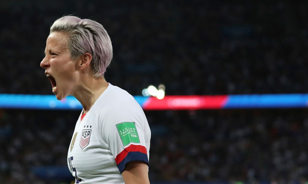 Photo of Megan Rapinoe, in profile, yelling in celebration after scoring her side’s second goal during the Women’s World Cup quarterfinal soccer match between France and the United States at the Parc des Princes, in Paris, June 28, 2019. The crowd is seen behind her in shadow.