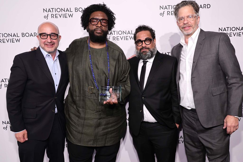 Producer David Dinerstein, director Ahmir “Questlove” Thompson, and producers Joseph Patel and Robert Fyvolent backstage with the award for Best Documentary for Summer of Soul during the National Board of Review annual awards gala in New York City on March 15. The men are dressed up, and Questlove holds the glass award.