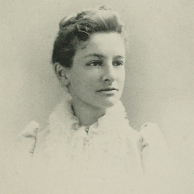 Black and white photo of Lucy Wheelock. A white woman with coifed hair looks to the right