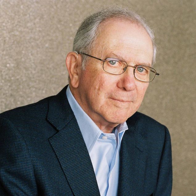 Noah Gordon looks at the camera in a suit and glasses