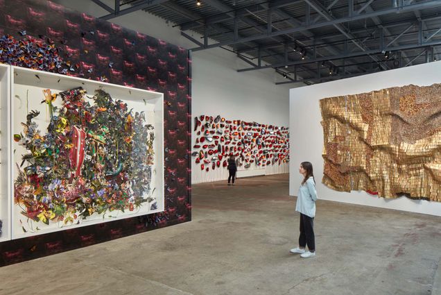 Photo of A visitor taking in the gallery space at the Institute of Contemporary Art/Boston’s Revival: Materials and Monumental Forms show. They stand before a very large art piece hung in the gallery.