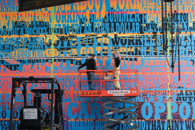 Joe Wardwell (CFA’99) (right) and artist assistant Quayshaun Owens installing Gotta Go to Work, Gotta Go to Work, Gotta Get a Job at the Institute of Contemporary Art (ICA) Watershed in East Boston. Photo by Kris Wilton, courtesy of the ICA