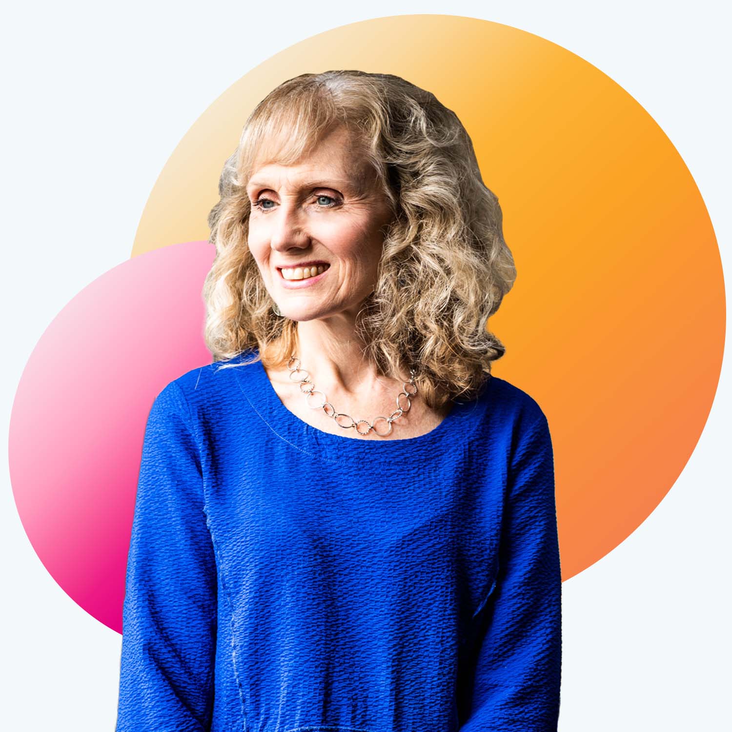 Portrait of Deborah Carr, a white woman with blonde hair who smiles and wears a long blue sweater. Decorative pink and orange spheres are photoshopped behind her portrait.