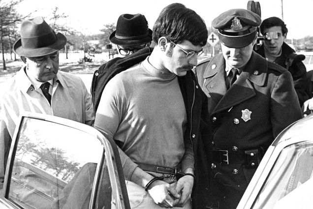SOUTH YARMOUTH, MA - MARCH 5: Sgt. Robert Bolduc, right, leads away Antone C. Costa, 24, of Provincetown, MA after his arrest in Boston and charges of the murders of two Rhode Island women at the Yarmouth Barracks, Massachusetts State Police Headquarters in South Yarmouth, MA on March 5, 1969. Three bodies of young women were discovered on Cape Cod in Truro's woods. Costa was arrested in a Marlboro St. apartment in Boston's Back Bay and arraigned the following day in Provincetown. (Photo by Bill Brett/The Boston Globe via Getty Images)