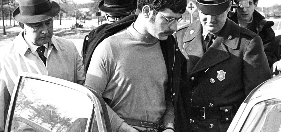 SOUTH YARMOUTH, MA - MARCH 5: Sgt. Robert Bolduc, right, leads away Antone C. Costa, 24, of Provincetown, MA after his arrest in Boston and charges of the murders of two Rhode Island women at the Yarmouth Barracks, Massachusetts State Police Headquarters in South Yarmouth, MA on March 5, 1969. Three bodies of young women were discovered on Cape Cod in Truro's woods. Costa was arrested in a Marlboro St. apartment in Boston's Back Bay and arraigned the following day in Provincetown. (Photo by Bill Brett/The Boston Globe via Getty Images)
