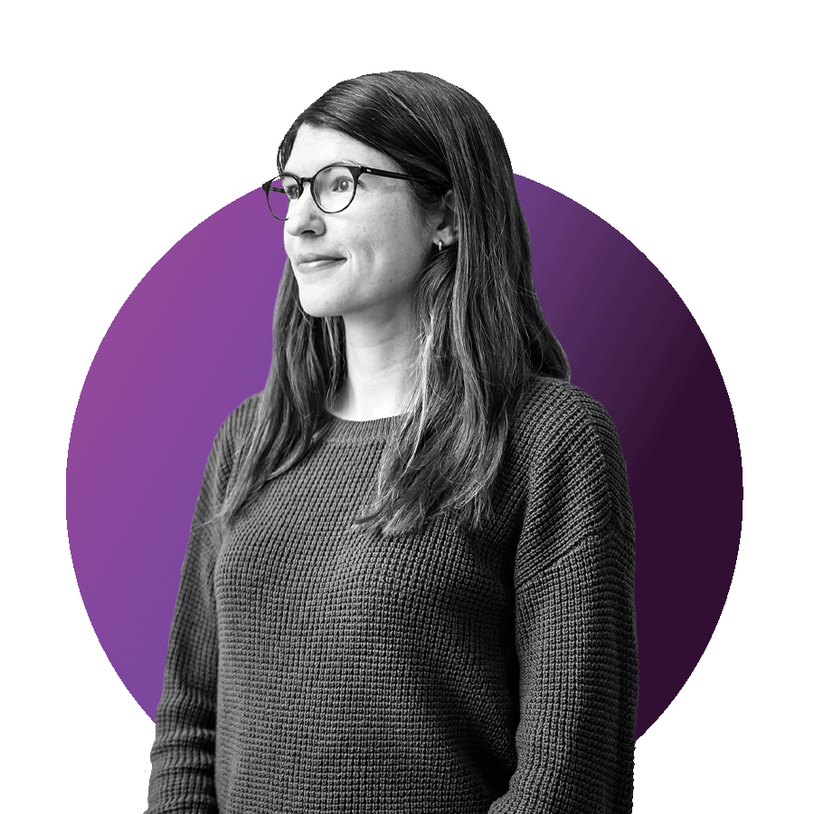 Black and white headshot photo of Laura Lewis, Assistant Professor of Biomedical Engineering. She wears a a long-sleeved, knit sweater and gazes to the left as she poses for the photo. Photo is overlaid over a circle with gradient light purple to dark purple colors.