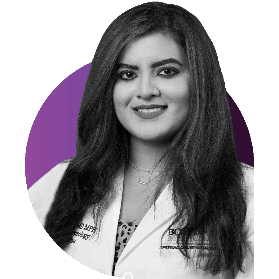 Black and white headshot photo of Naina Limbekar, BU MED assistant professor of neurology, a physician at Boston Medical Center, and host of the podcast "Sleep On It!". She wears a white lab coat and smiles as she poses for the camera. Photo is overlaid over a circle with gradient light purple to dark purple colors.