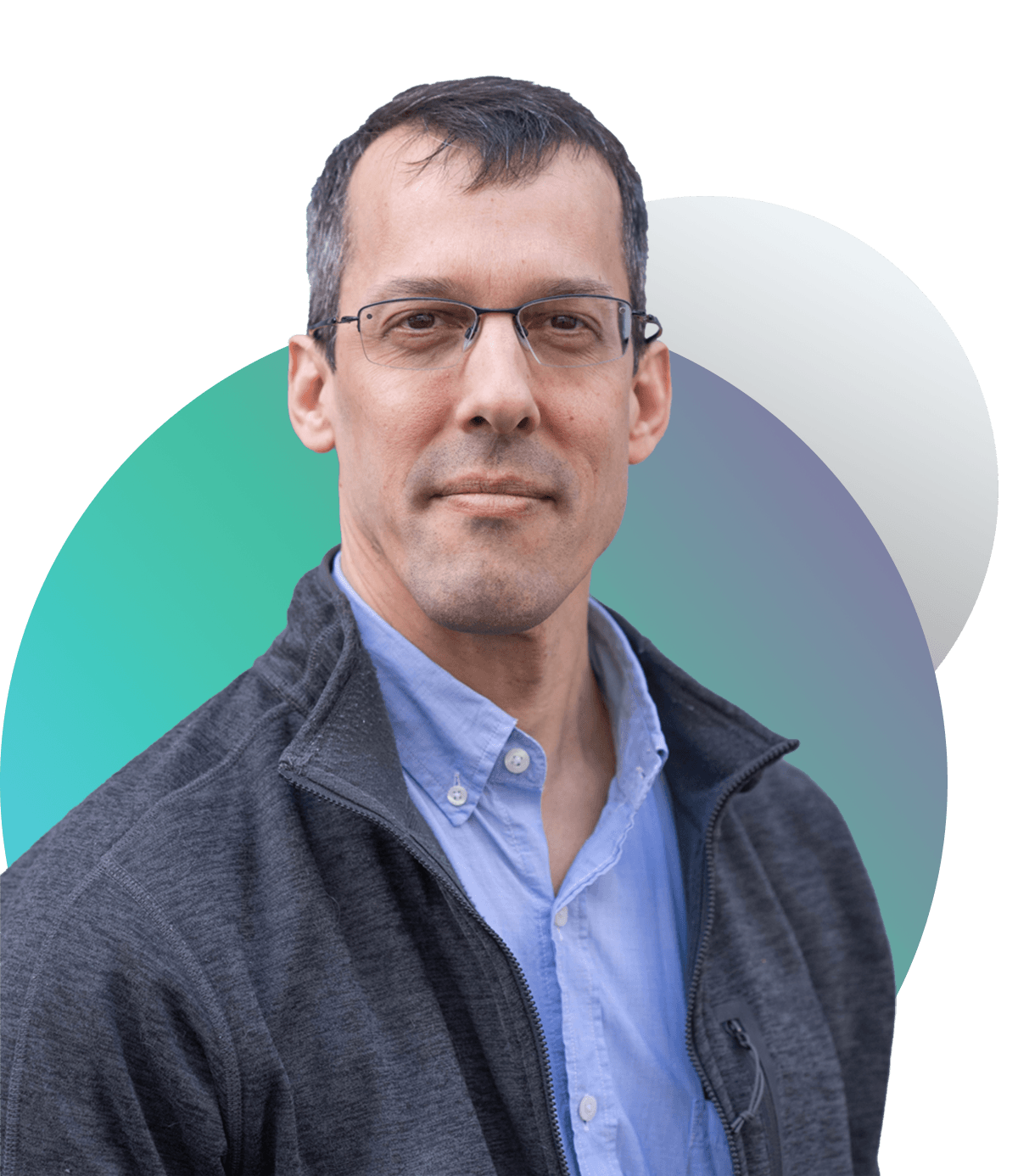 Headshot of Eric Kolaczyk, a white man with glasses who wears a gray jacket and blue collared shirt. He slightly smiles and is framed by two gradient circles, one is gray, the other is blue, green and purple.