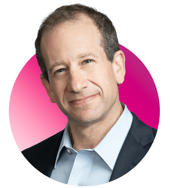 Photo of Jonathan Zaff, a White middle-aged man, who smiles slightly and wears a suit. A pink gradient sphere appears behind his headshot for emphasis.