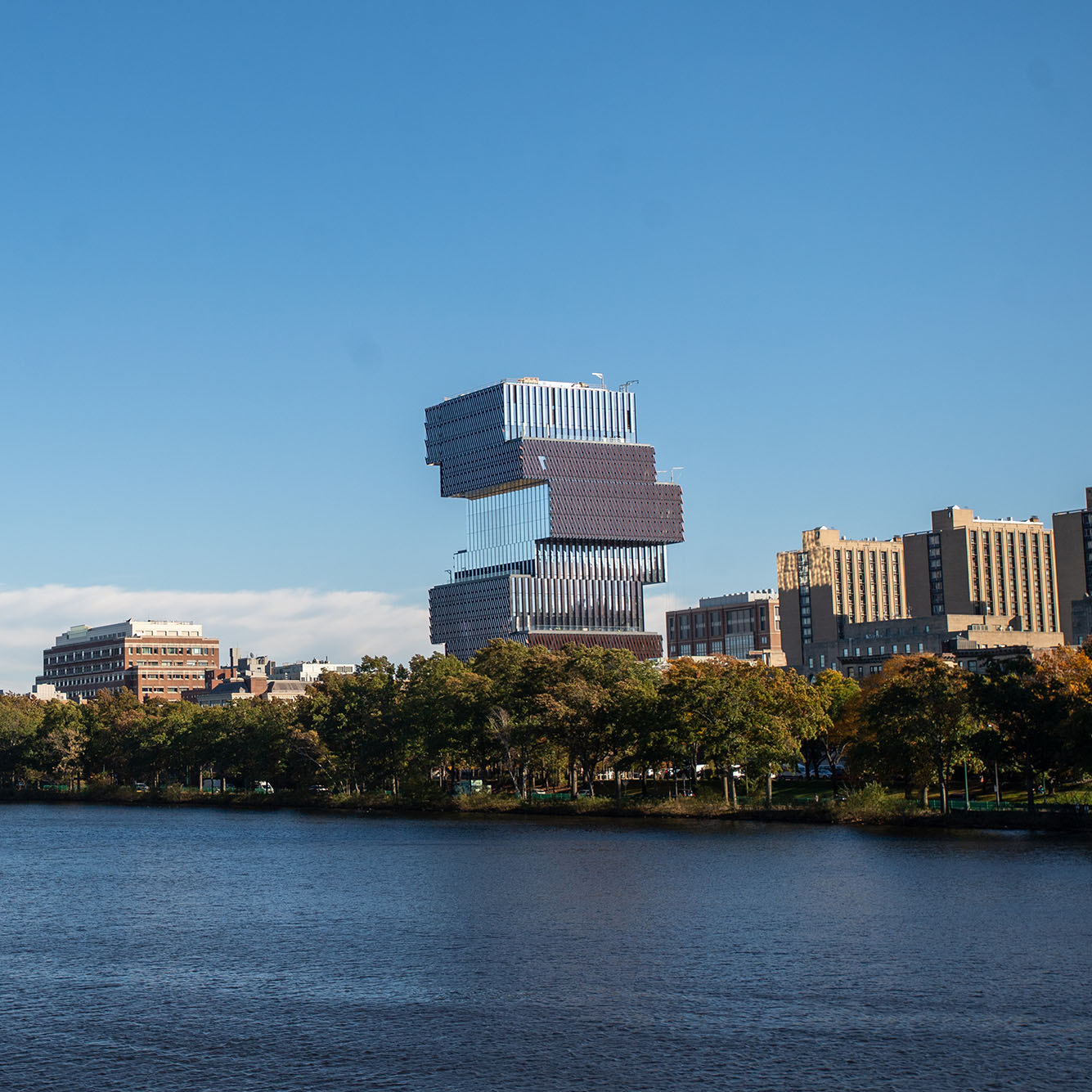 Photo: A photo of the CCDS on Boston University's campus. It is shown from across the Charles River, among the Boston skyline.