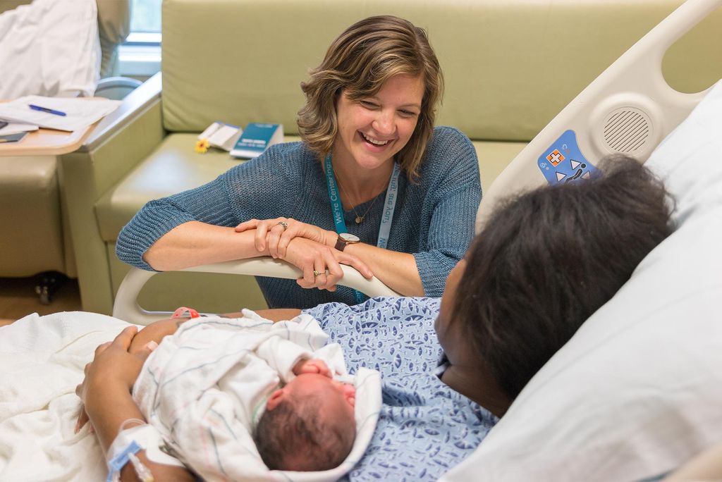 A nurse and a mother with newborn baby at BMC in Boston. Babies born at Boston Medical Center, like this one, have put the neonatal ICU at full capacity of late. Photo courtesy of Boston Medical Center