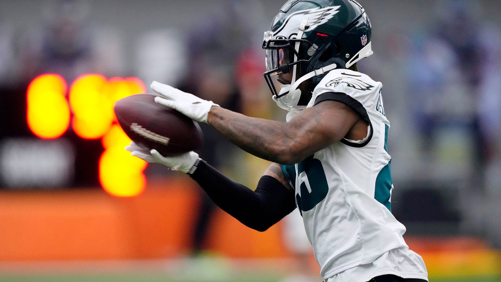 Photo: Philadelphia Eagles' C.J. Gardner-Johnson catches a pass during practice at the NFL football team's training facility, Friday, Feb. 3, 2023, in Philadelphia. A Black man wearing a dark green and white Eagles' football uniform and helmet catches a football in his hands.