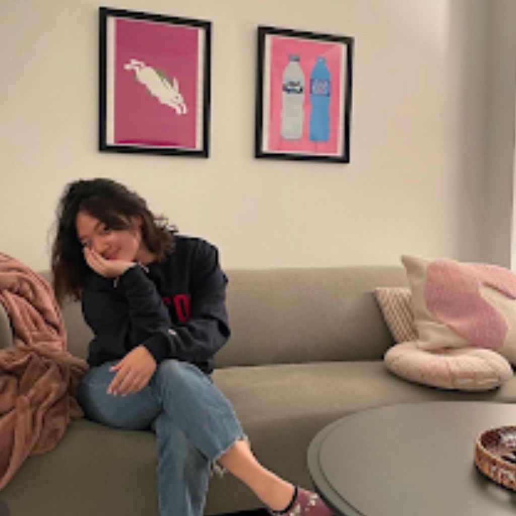 Student, Alexa Sudarto (COM'23), is sitting on a couch with her legs crossed and is smiling for a photo.
Picture Credit: Alexa Sudarto (COM'23)