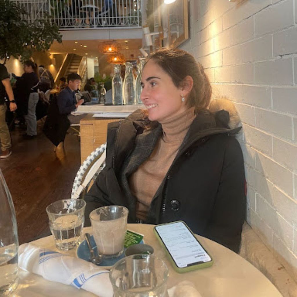 Student, Beatriz Iglesias, is at a restaurant with a jacket on, smiling off into the distance.
Picture credit: Beatriz Iglesias (QST'23)
