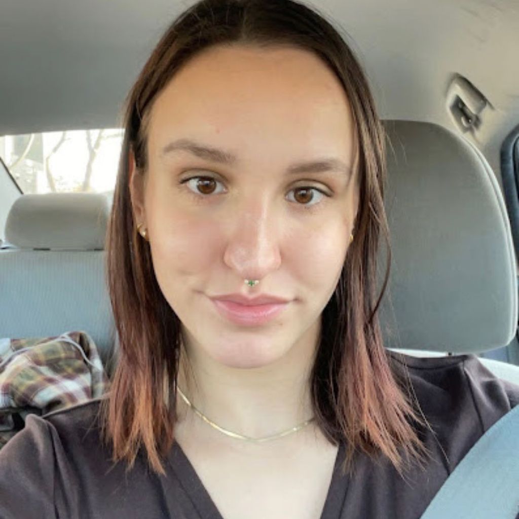 Student, Charlotte Bausha, takes a photo of herself in the front seat of a car. She is smiling softly.
Picture credit: Charlotte Bausha (CAS'23)