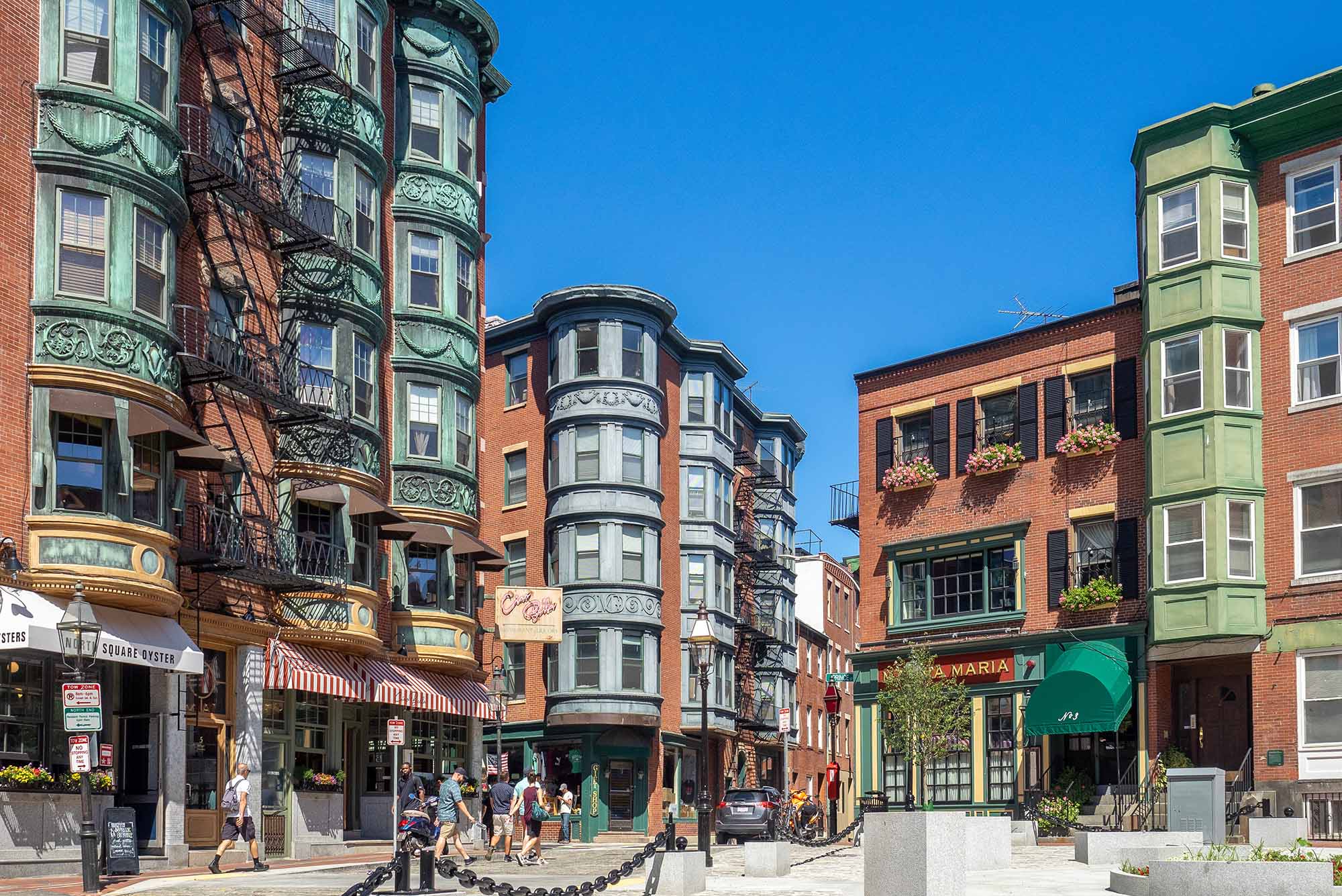 Photo: A bustling square in Boston's North End, surrounded by brick buildings