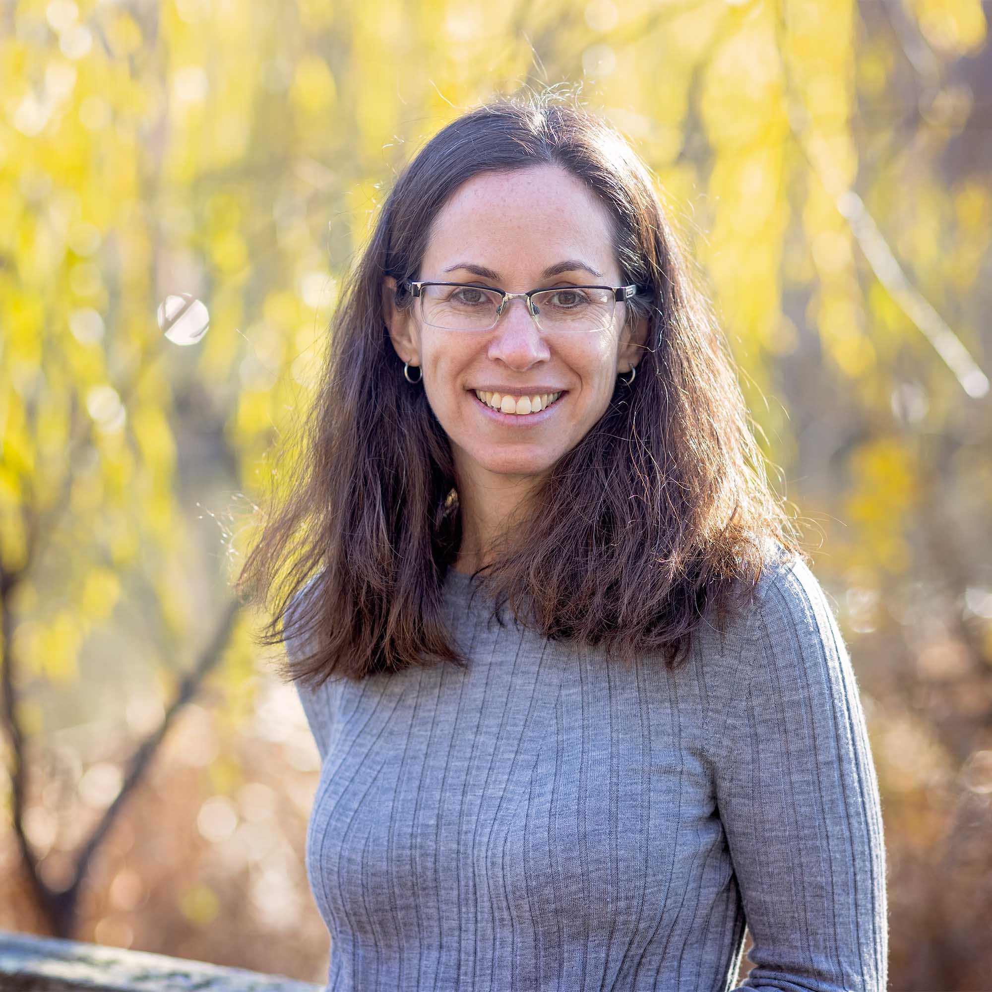 Photo: A headshot portrait of Pamela Templer Garon, a white woman wearing glasses