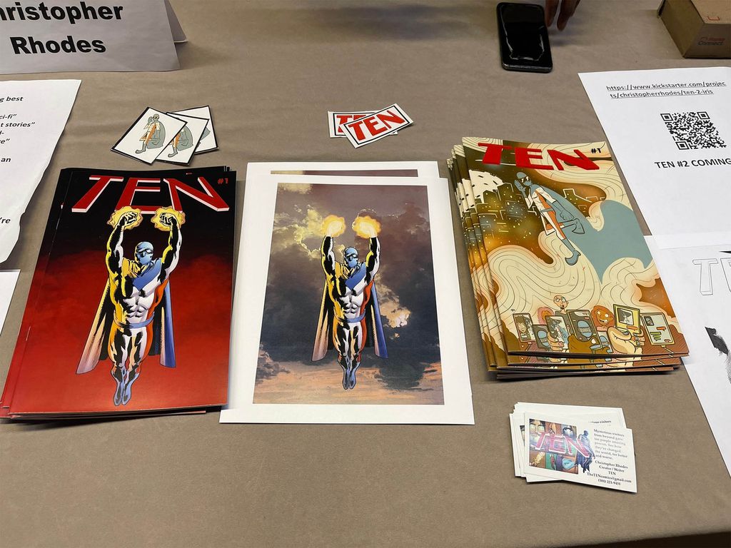 Photo: A table displays three different comic books written by Chris Rhodes.
