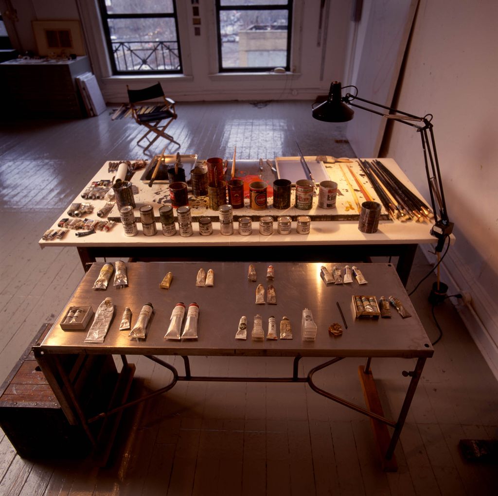 Photo: Two tables feature carefully arranged painting supplies including but not limited to brushes, paints, and paper.