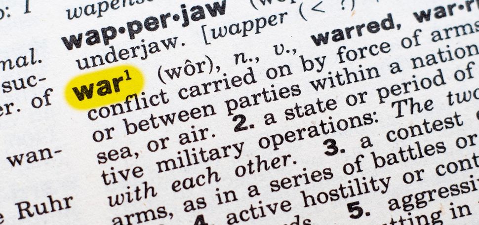 Photo: Closeup shot of a dictionary page opened up to the entry for the word "war". The word "war" is highlighted in neon yellow.