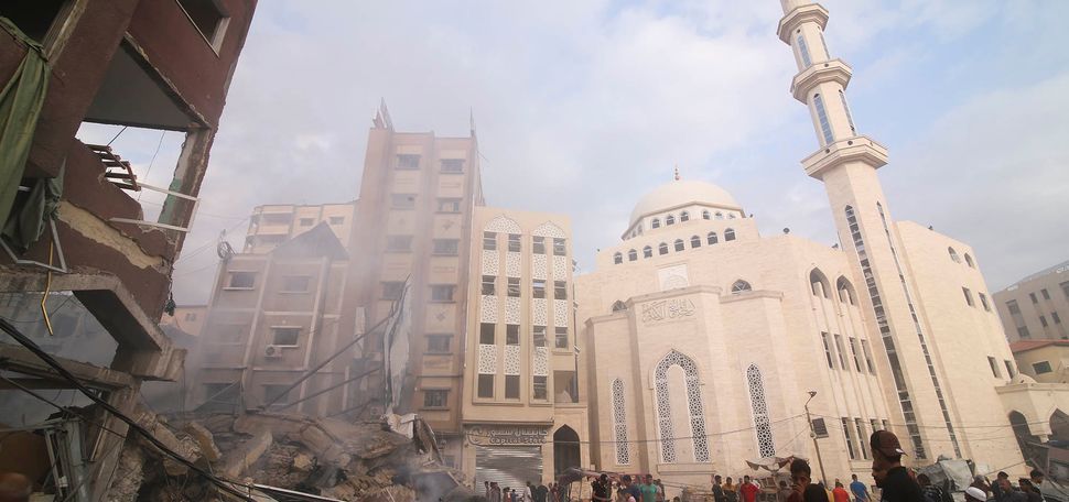 Photo: Palestinians inspect the damage of destroyed building after Israeli airstrikes in Khan Younis, Gaza Strip