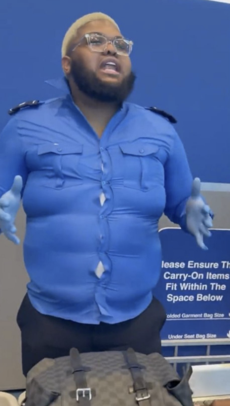 Photo courtesty of @teefortilly on Twitter (X). This is a screenshot from a comedian's skit pretending to be a TSA employee. He is wearing a TSA uniform that's extremely small on him.