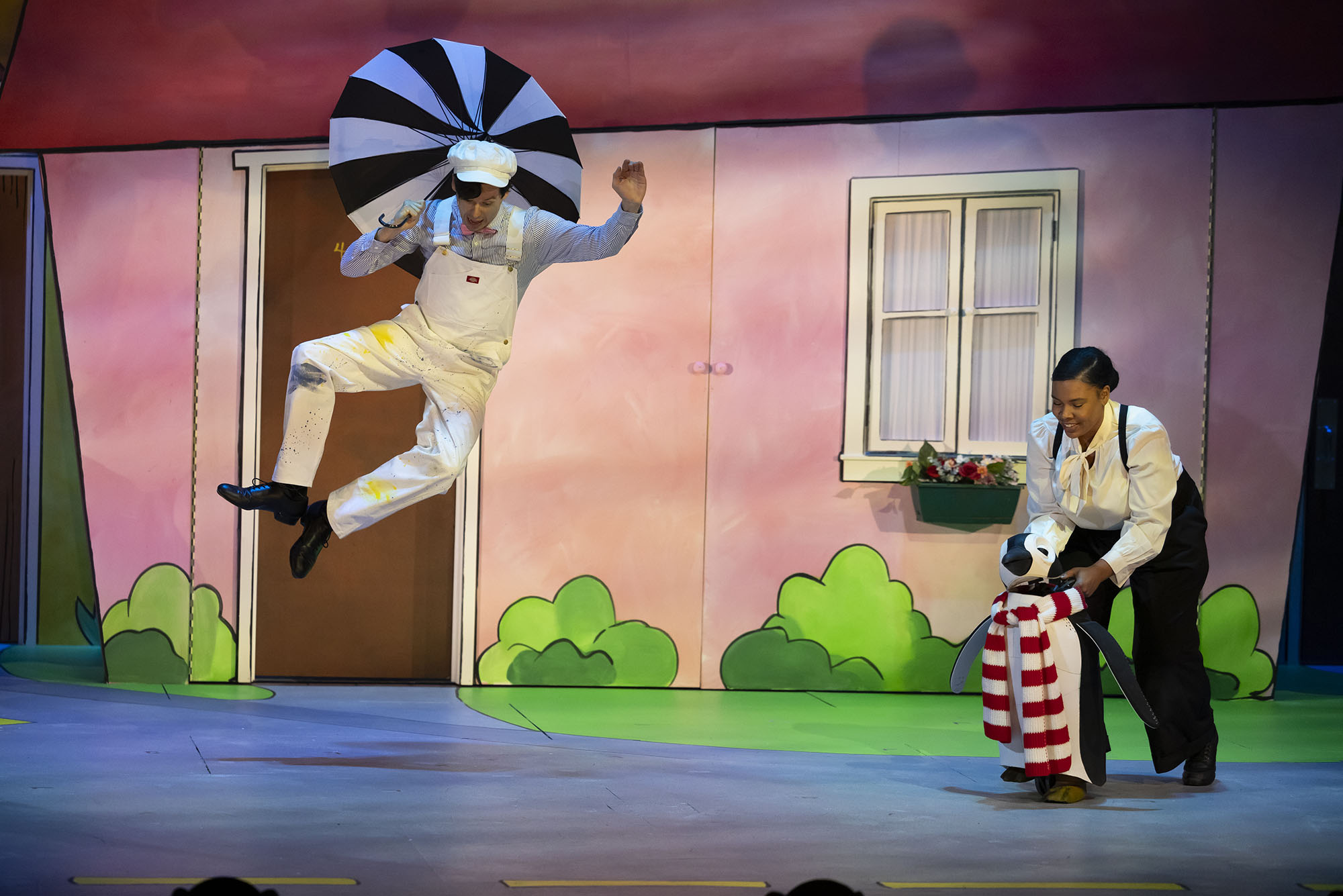 Photo: Mr. Popper jumps up with a stripped umbrella and heel clicks.