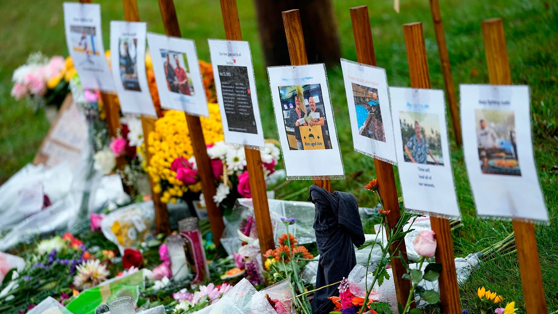 Photo: ain soaked memorials for those who died in a mass shooting sit along the roadside by Schemengees Bar.