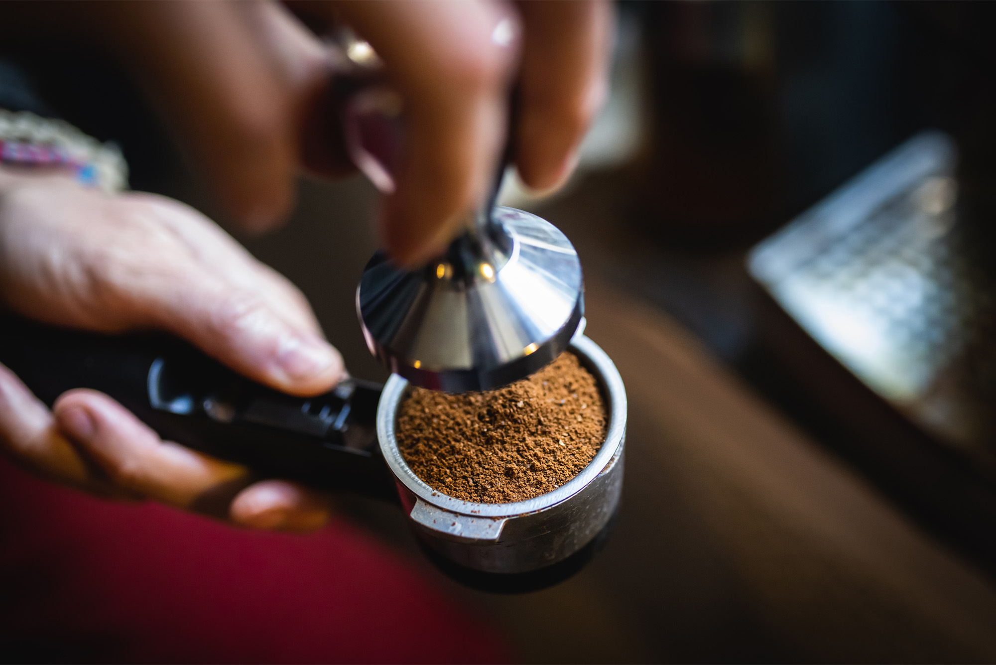 Photo: An espresso machine wand being loaded with coffee
