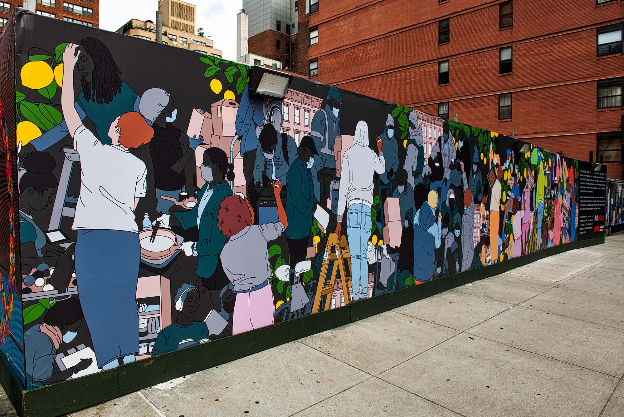 Photo: A colorful mural on the side of a hospital featuring different figures doing various community jobs