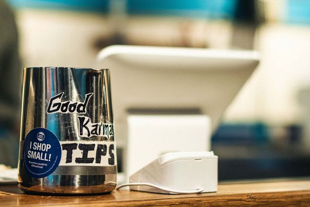 Photo: A tip jar with a sticker reading "Good Karma: Tips: