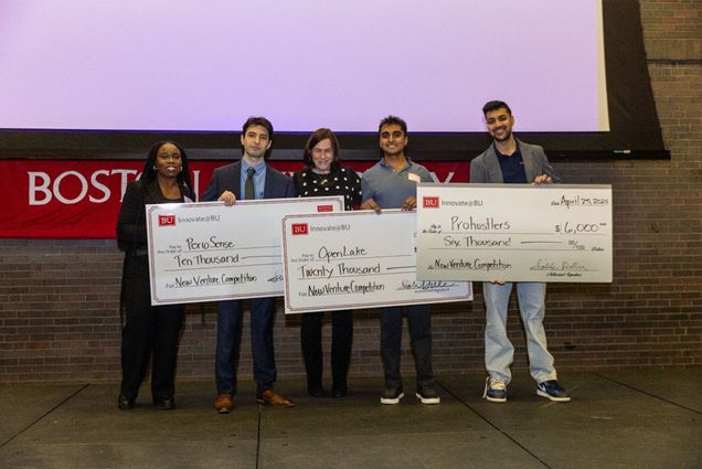 Photo: A group of students holding large checks at a recent innovation competition at Boston University