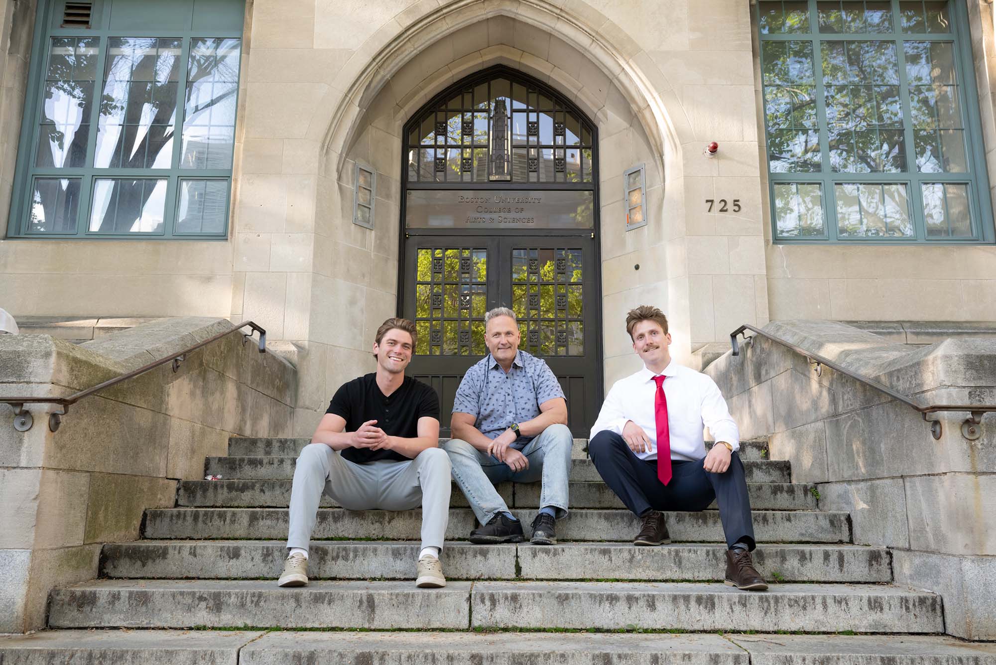 Photo: A picture of a father sitting on the steps with his sons on either side of them. The building behind them says "Boston University College of Arts & Sciences"