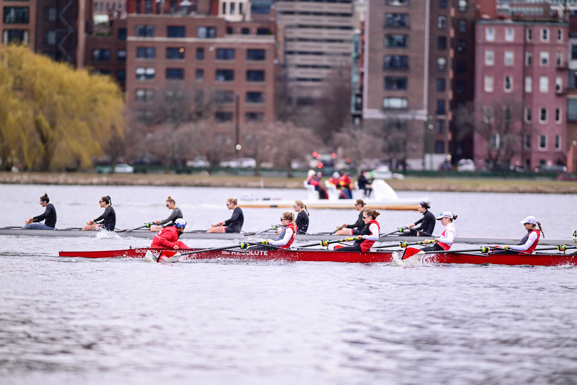 Photo: A picture of a women's team rowing wearing clothes with red accents