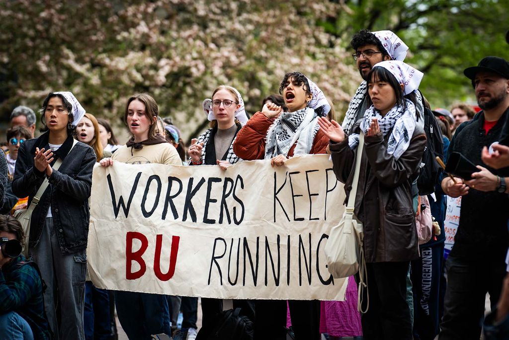 Photo: A picture of people at a rally carrying a sign that says "Workers Keep BU Running"