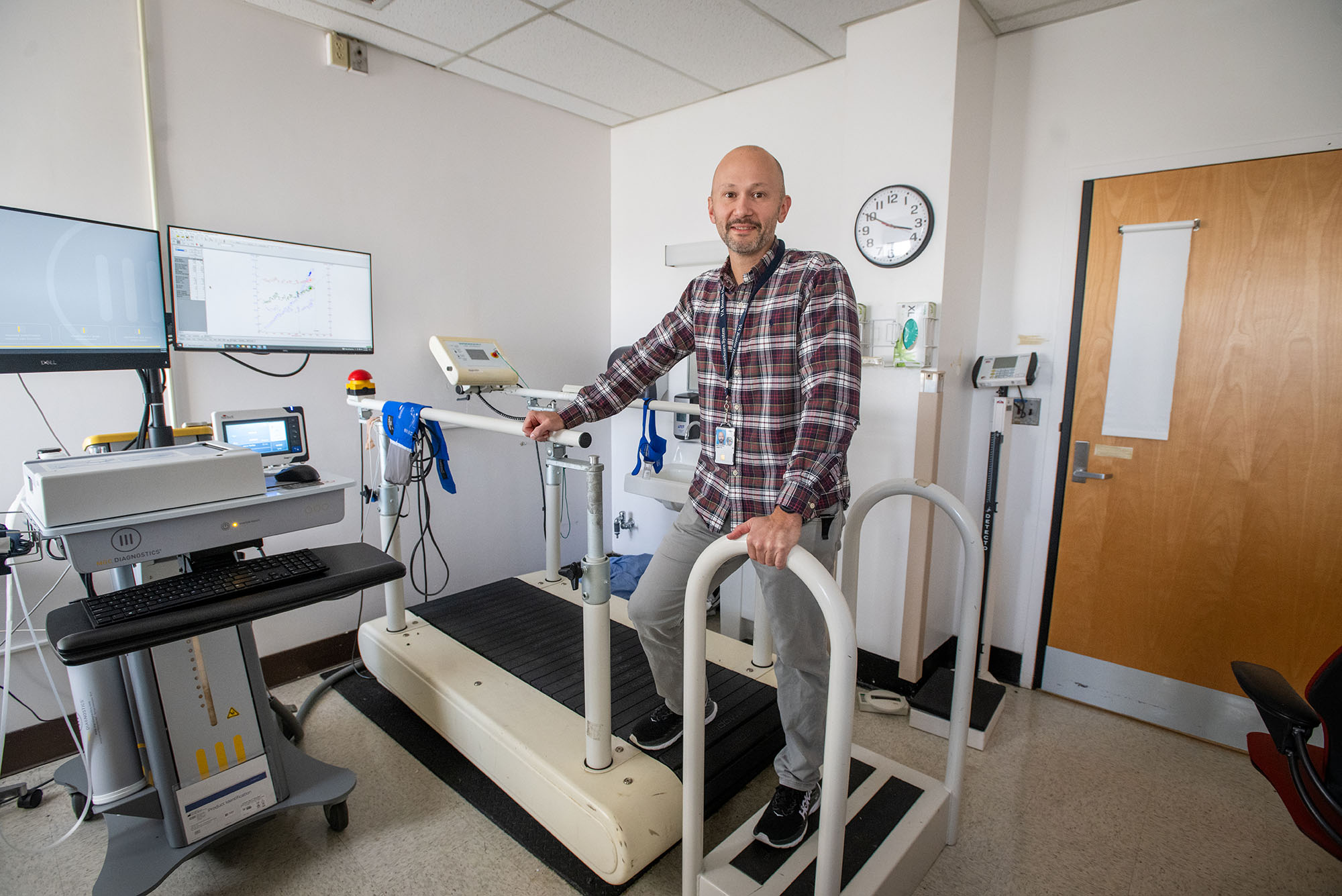 Photo: A picture of James Whitworth, a BU MED assistant professor, standing on a treadmill in an activity lab.