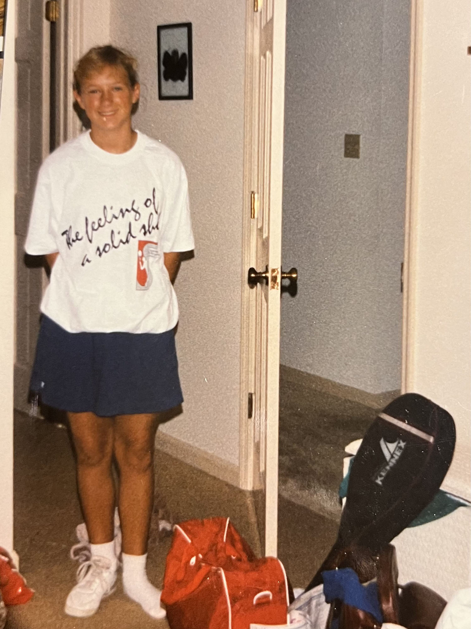 Photo: A young photo of Wendy Goldberg in a white t-shirt, black short, and tennis shoes.