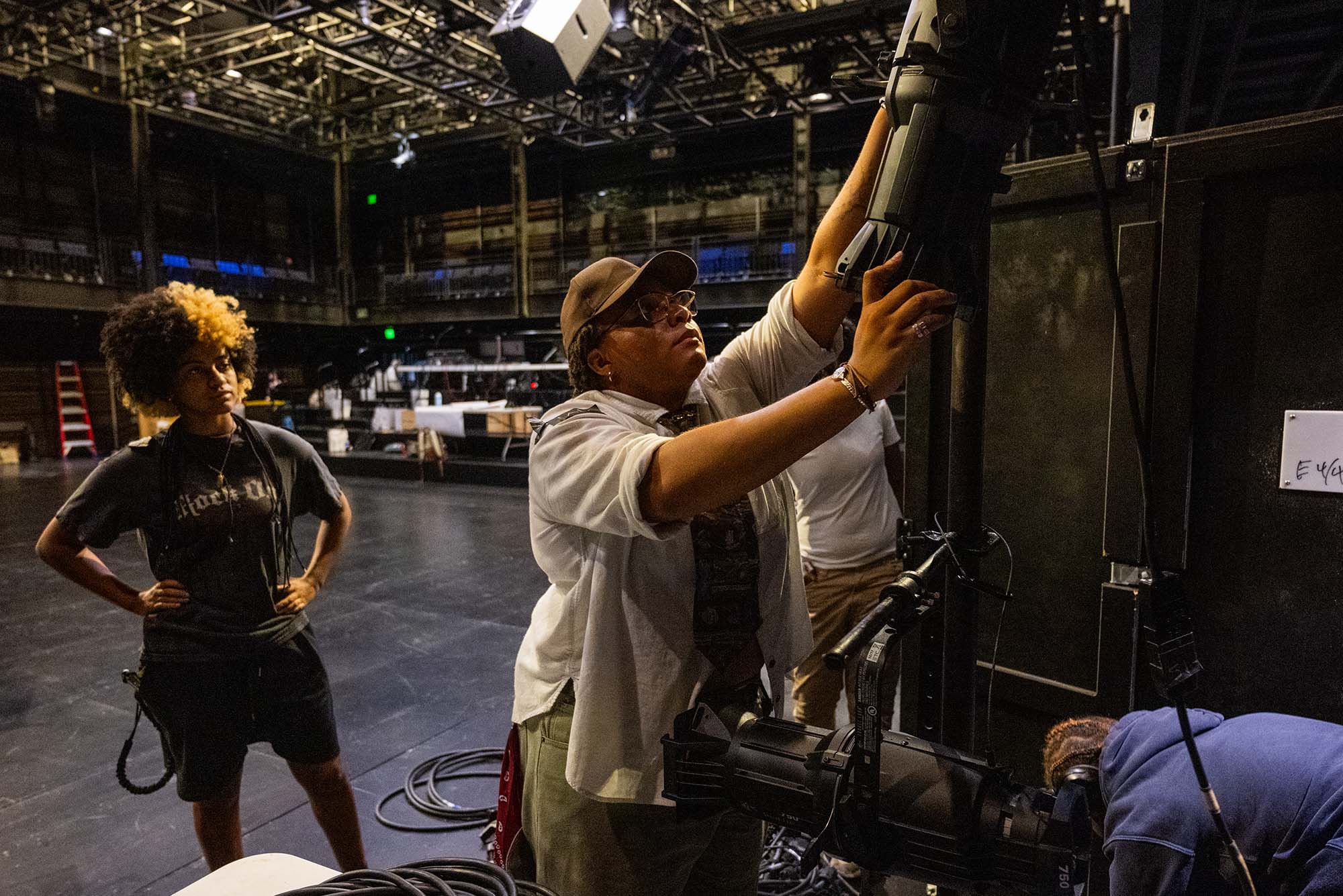 Photo: Lala Cooks-Beeks, 18, in white, works on lighting in Booth Theater