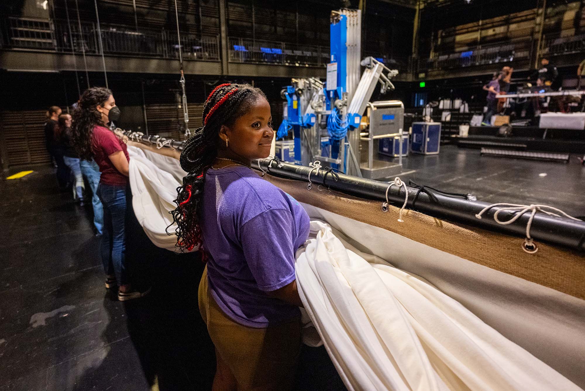 Photo: Sophia Williams, 16, along with the other students and mentors care for the softwoods on set at Booth Theater