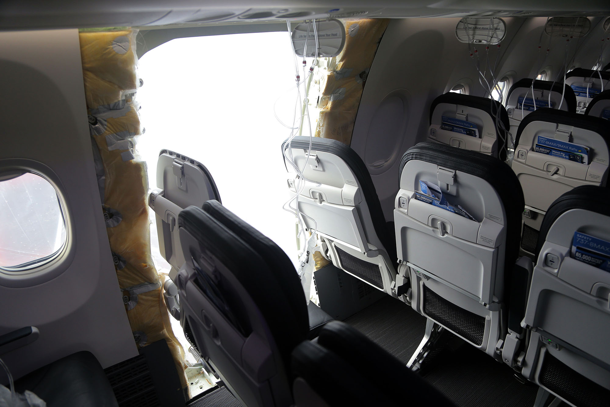 Photo: A picture of a hole in a Boeing plane as a result of a wall panel blowing out mid-flight