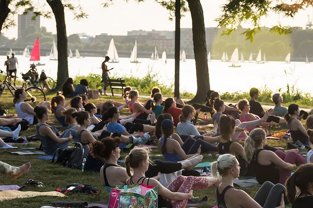 Photo: A population of people doing yoga in a free public green space.