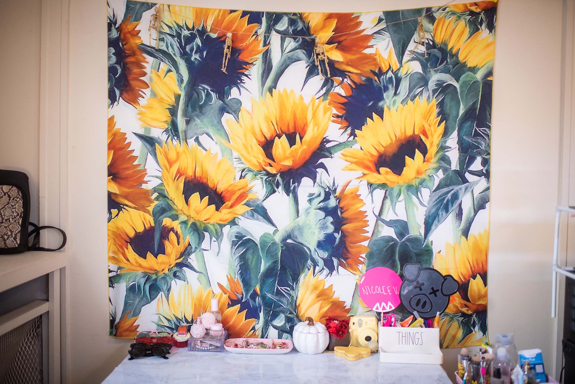 Photo: A picture of a sunflower tapestry in a dorm room