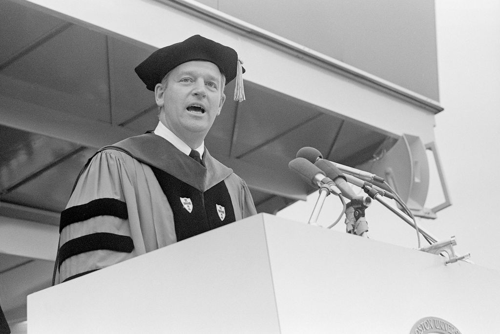 Photo of former BU president Arland Christ Janer speaking at a podium in regalia at Boston University, black and white