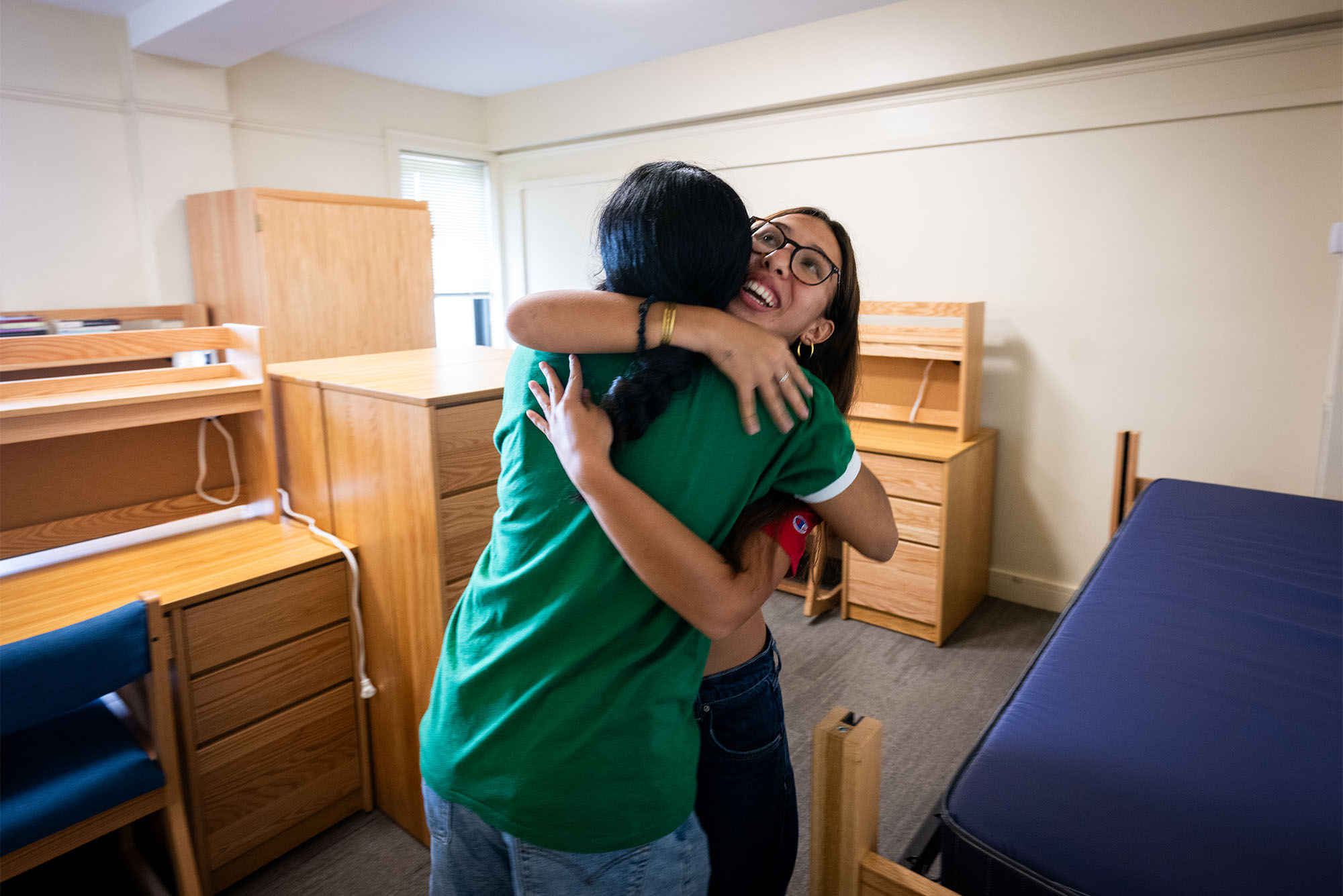 Photo: Inoa Manfredy (CAS’27), embraces her new roommate, Riddhi Kasralikar (CAS’27), in green, upon arrival to move into their shared room at Kilachand Honors College