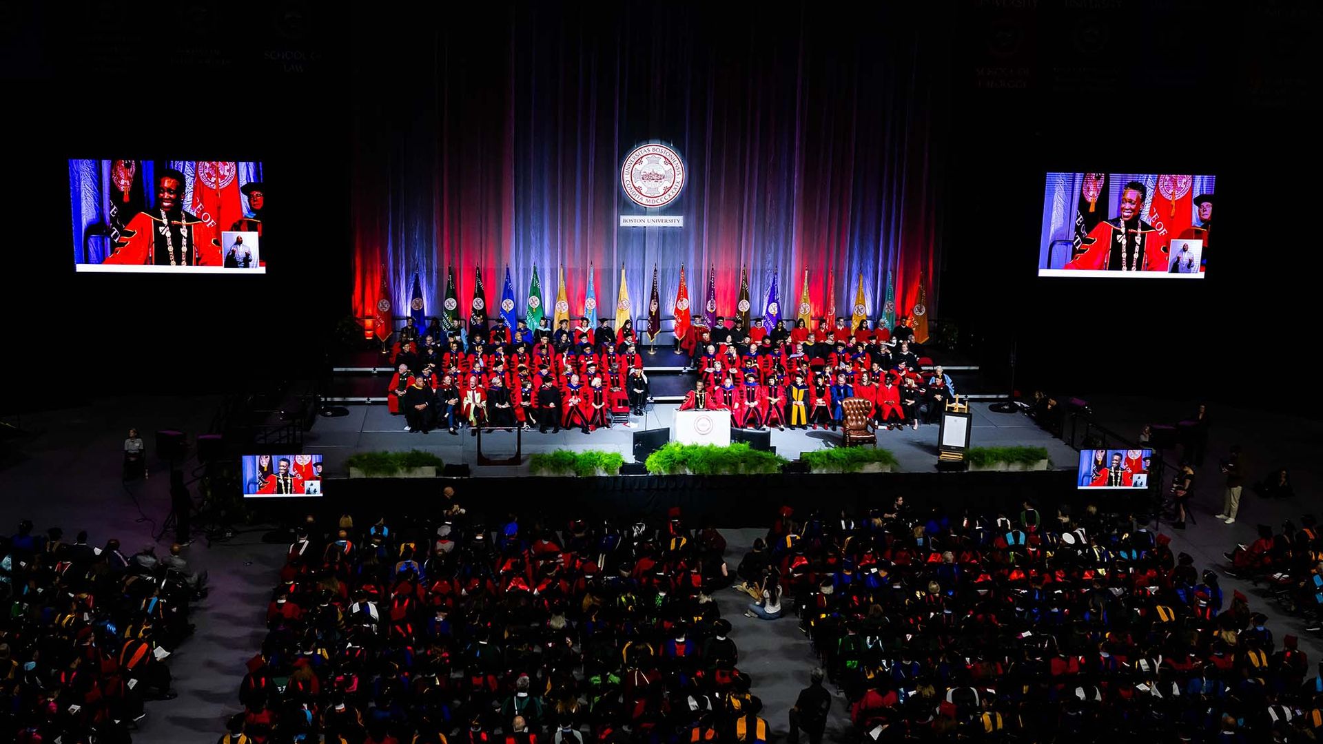 Photo: A Large crowd gathers in a dark arena to watch the inauguration of Melissa L Gilliam as Boston University's 11th President