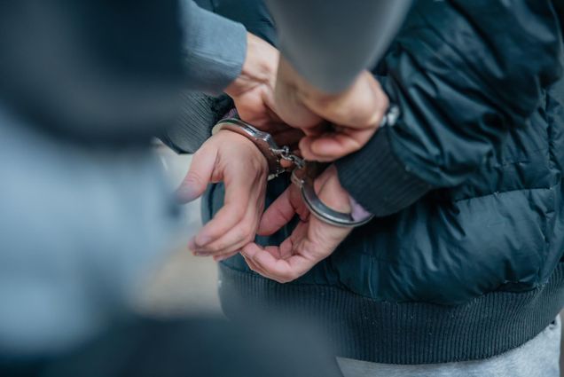 Photo: A stock image of someone being put in handcuffs.
