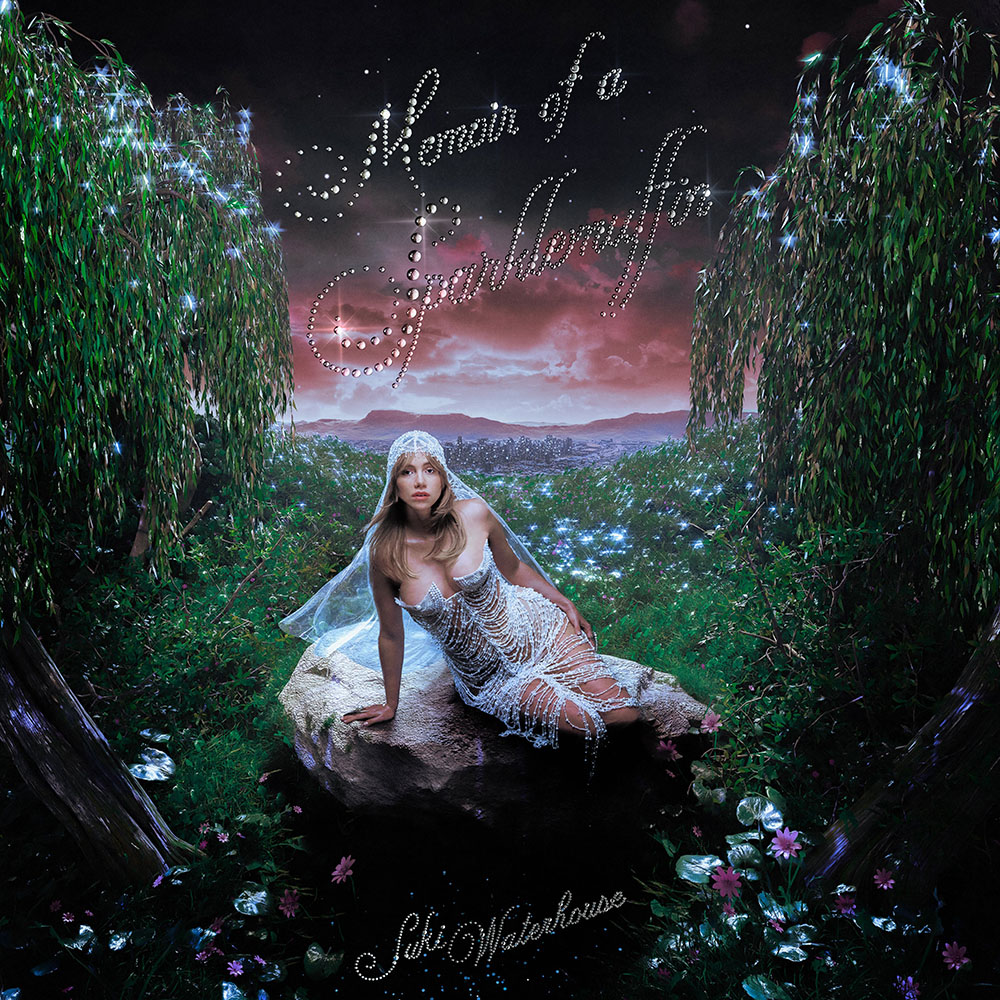 Photo: Album cover for "Memoir of a Sparklemuffin" by Suki Waterhouse. It pictures her in sheer white clothing in the middle of an ethereal forest