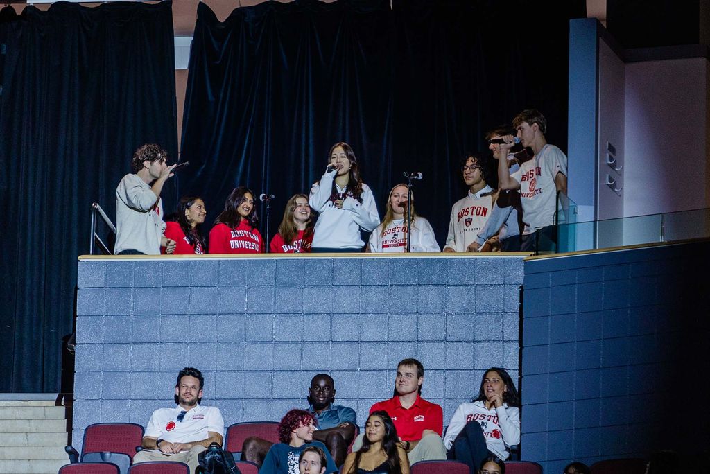Photo: The BU Treblemakers stand in a lit balcony. They were among the student performers who took part in the inauguration ceremony.